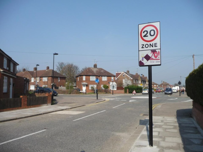 A UK 20mph zone entry sign, marking the start of the zone, on a residential street